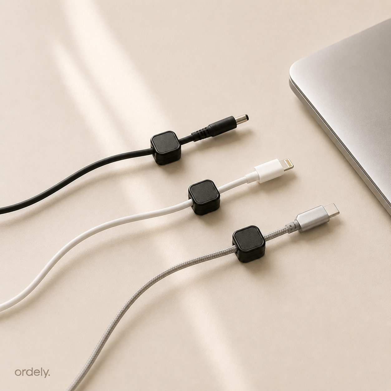 Set of three multi-device cables with connectors on a beige surface, branded 'ordely'.